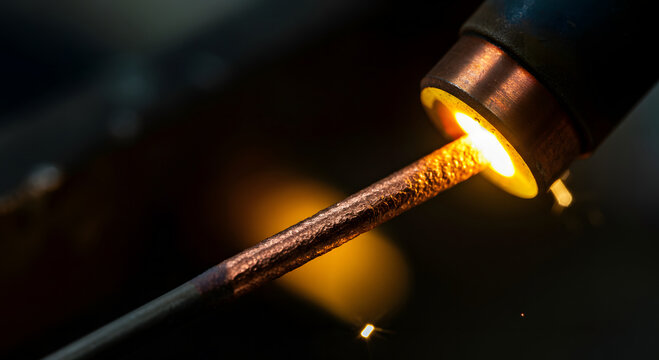 Extreme macro copper tipped electrical welding electrode spark molten sparks arc.