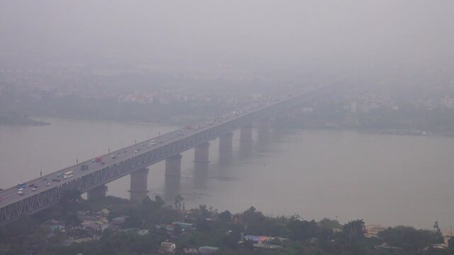 The automobile bridge over the Mekong River on a smog day, industrial mist. mog over the city. Hanoi, as the most polluted city in the world, industrial mist is common during the winter months