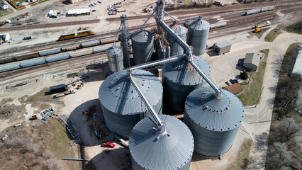 Aerial close up of grain silos and rail freight infrastructure in industrial area © Viola