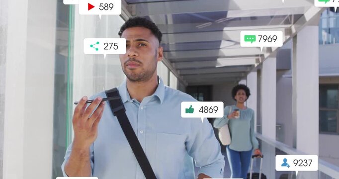 Walking man in blue shirt speaking into phone to send text while notifications arriving in walkway