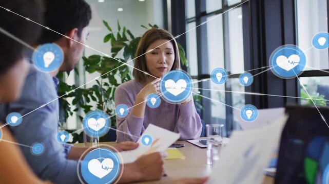 Gesturing lead purple sweater table blue icon appearing at hands visualizing data on laptop reports