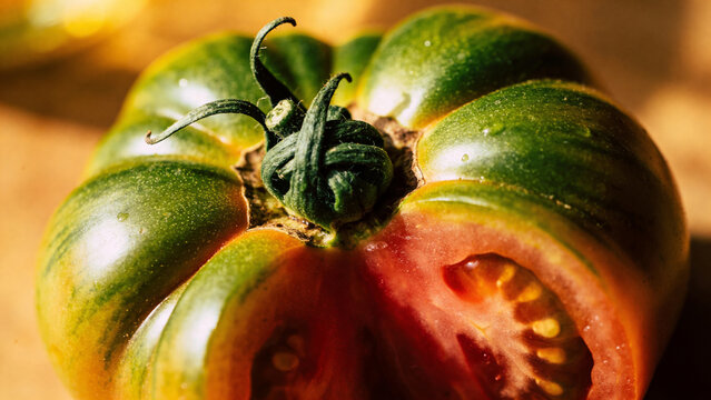 Fresh tomato cut in half showing inside texture and color for agriculture industry closeup