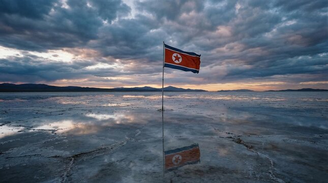 North Korean flag waves over a vast, reflective salt flat at sunset