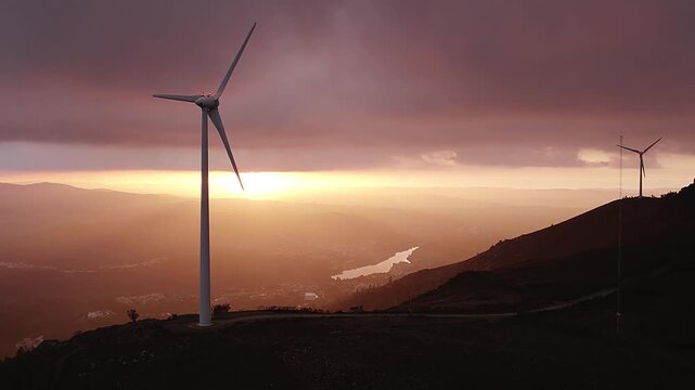Wind turbine on Serra da Boneca in Penafiel Porto District Norte Portugal overlooking Douro River valley under golden sunset light in Iberian Peninsula European Union setting, drone orbit reveal