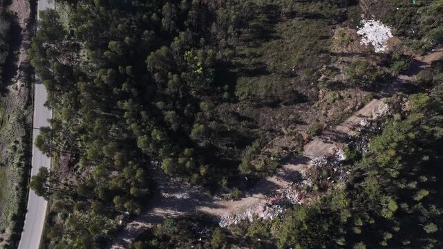 Drone shot of thrash in the middle of the forest in Portugal.