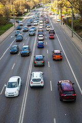 Traffic on a four-lane highway during the day on a sunny day in a big city © Oleksandr Davydenko
