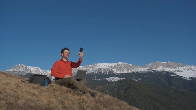 Frustrated digital nomad searching for mobile phone signal on remote Carpathian mountain hill static tripod hero shot 4K