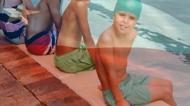 Animation of flag of chile over happy diverse children having fun at swimming pool