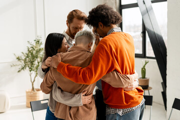 Diverse group embracing for support and unity