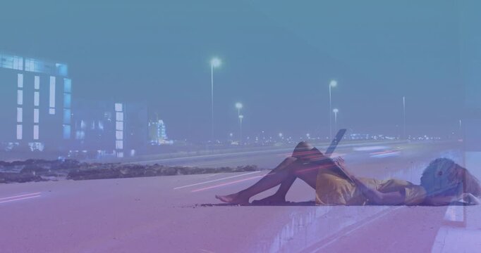 Woman lying on shore lifting tablet, scrolling as light trails mirroring tablet motion with tech