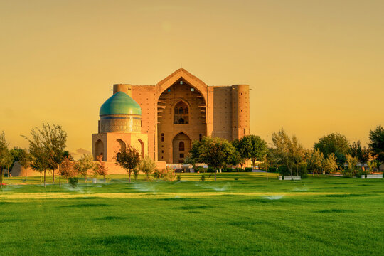 Turkestan, Kazakhstan - June 03, 2025: Scenic early morning sunrise view of the historical Mausoleum of Khoja Ahmed Yasawi and Rabia Sultan Begim Mausoleum complex  with water sprinklers