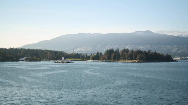 Seaplane landing near floating marine gas station in Vancouver Harbour, British Columbia, Canada. 4k footage