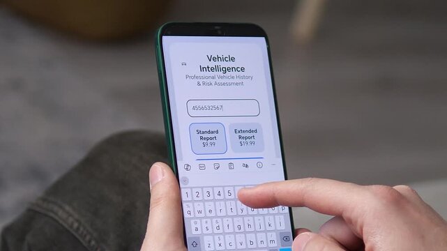 Modern app interface for vehicle intelligence and history reports. Close-up of hands entering VIN code to buy car data. Ideal for automotive tech, consumer reviews, and online service ads. Seamless