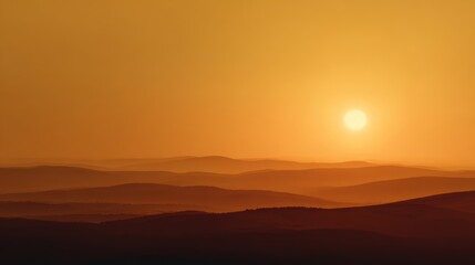 Obraz premium Sunset Over Rolling Hills with Warm Colors and Soft Light