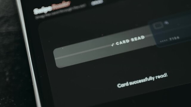 Finger drags the card across the reader to perform a payment from a mobile banking application