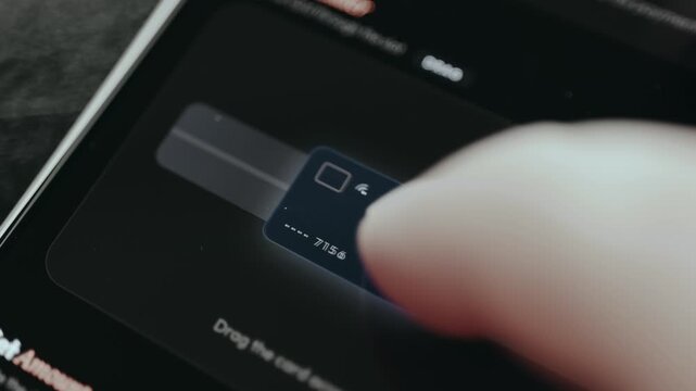 Finger swiping a card across the reader to make a mobile banking payment, card successfully read