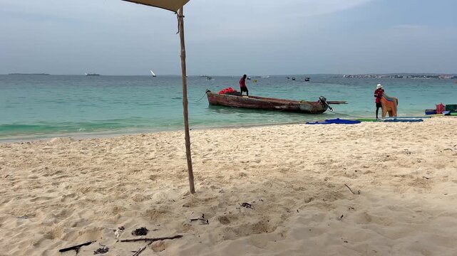 Local fishermen on traditional dhow boat Zanzibar Tanzania