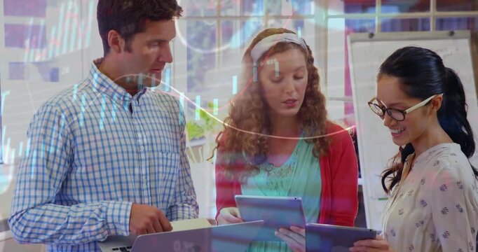 Three colleagues holding laptop, tablets, center woman tapping tablet initiating finance chart view