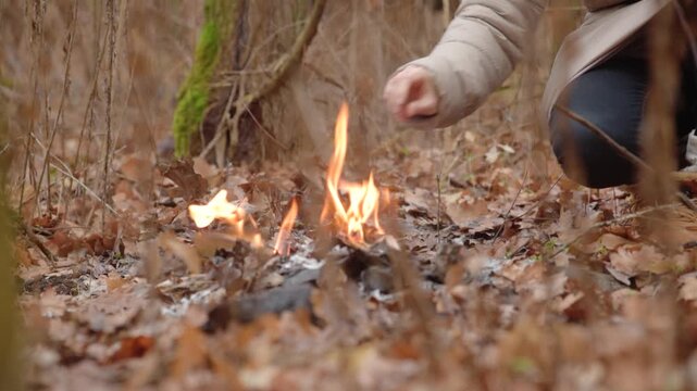 Closeup photo of woman burning confidential documents outdoor Emotional release and symbolic closure. Destruction of confidential information in isolation. Personal transformation through fire ritual.