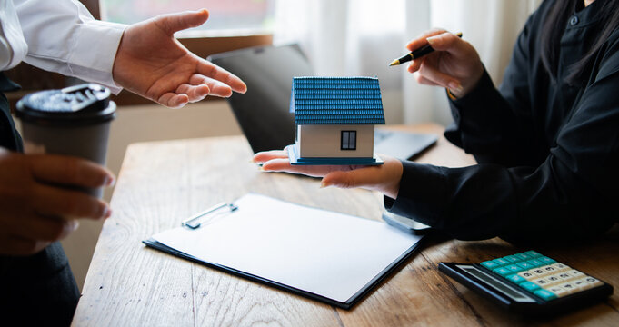 Business professionals meet with real estate agents to discuss real estate investments, sign contracts, apply for mortgages, plan purchases, ownership, and successfully secure approval for 