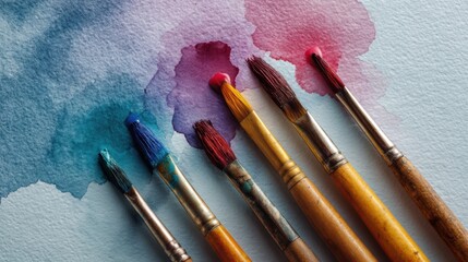Fototapeta premium Colorful Paint Brushes and Watercolor Swatches on White Paper
