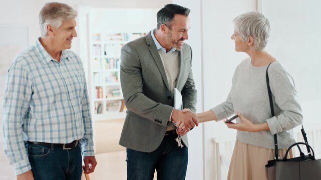 Handshake, couple and real estate agent with keys to new home for property sale, purchase or picture. Moving, mature buyers and realtor shaking hands for ownership transfer, mortgage success or photo