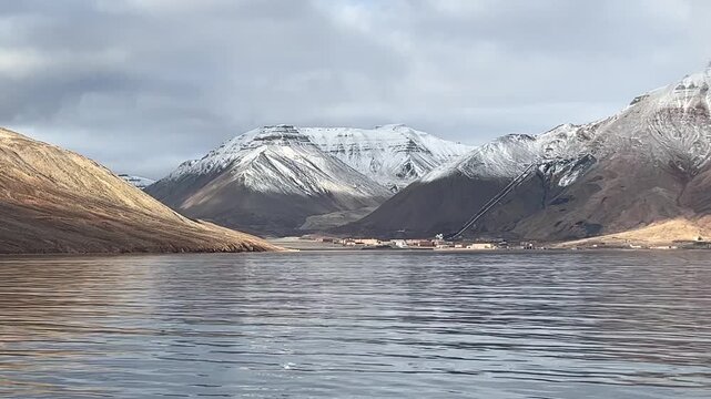 View of the abandoned mining town of Pyramiden in Svalbard, Norway, with its mountain backdrop and fjord