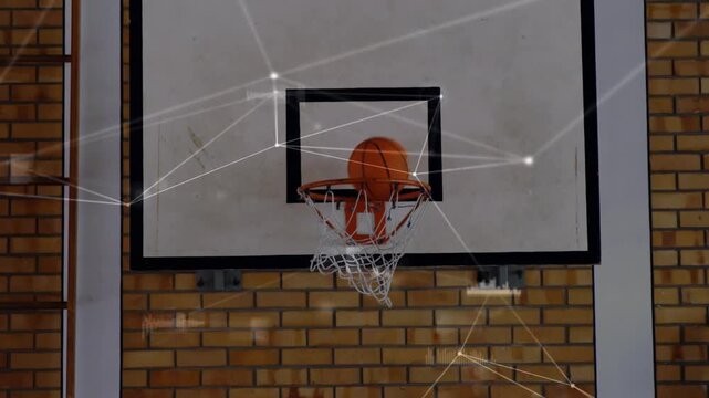 Animation of connected dots with graph icons over basket ball falling in net at basketball court