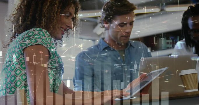 Woman tapping tablet and showing animated finance charts over office while colleague reviewing data