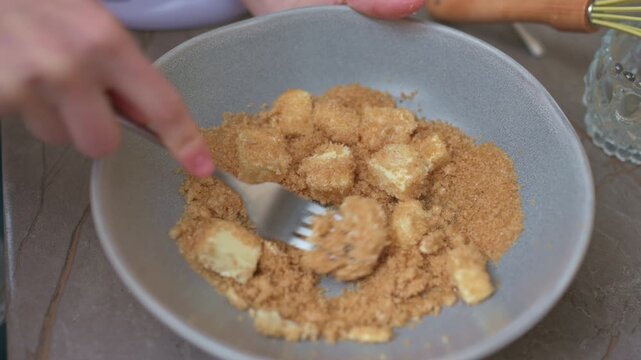 Fork Mashing Banana Into Brown Sugar Closeup Of Bakers Hands Crushing Ripe Banana Pieces Into Brown Sugar