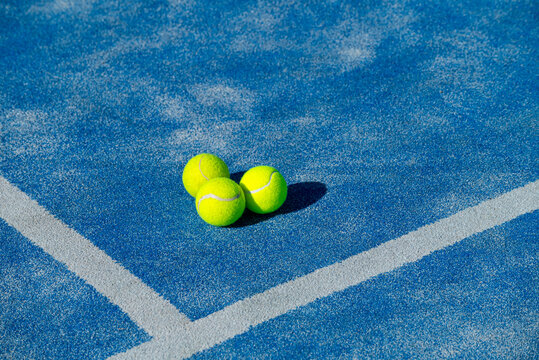 Three Padel Balls on Blue Court The Concept of Racket Sports.