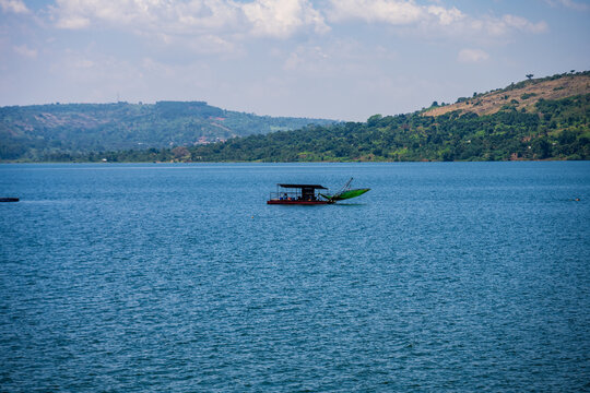 Fishing boat on Lake Victoria near Entebbe with wooded hills in the background