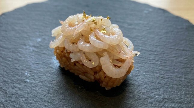 Shiro ebi nigiri sushi with gold leaf