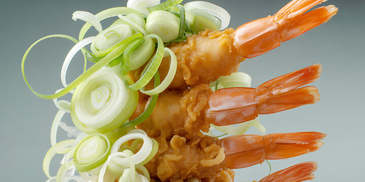 Delicious golden fried shrimp garnished with fresh thinly sliced green onions and white scallions