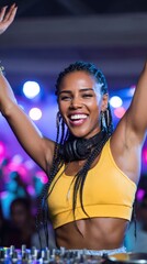 Female african young dj smiling at nightclub party with headphones and raised arms