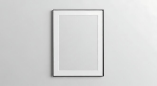 Empty vertical black frame hanging on a plain white wall surface blank