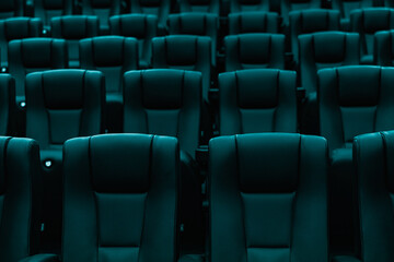 Fototapeta premium Rows of empty turquoise cinema seats in modern movie theater