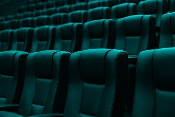 Obraz premium Rows of empty turquoise cinema seats in modern movie theater