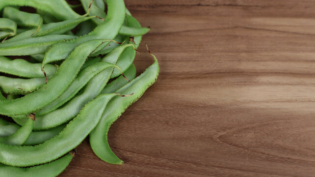 Fresh Green Hyacinth Beans on Wooden Table with Copy Space