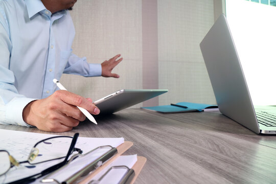 Business Professional Using Tablet and Stylus at Modern Office Desk