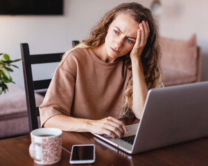 Portrait of tired young business woman with laptop computer