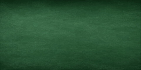 Fototapeta premium Empty vintage green chalkboard background with a grunge textured pattern on a blank wall surface design