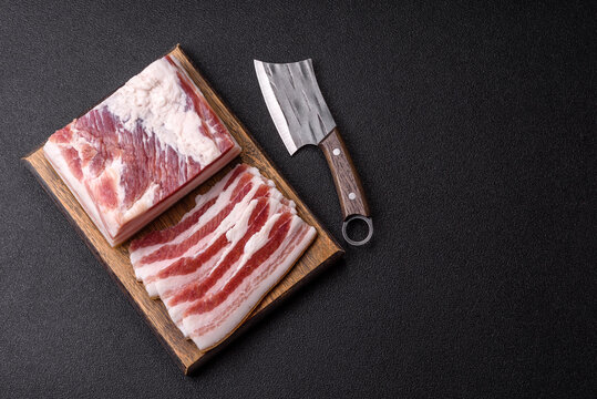 Raw fresh bacon slices with layers of meat or prosciutto prepared for frying. Raw bacon