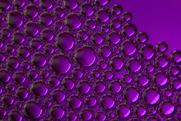 A close-up abstract shot of purple bubbles. © mirukser