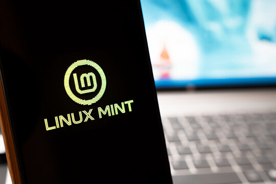 Warsaw, Poland - April 10, 2026: Close-up of a smartphone displaying the Linux Mint logo on a dark screen, symbolizing modern technology, software development, and open-source systems.