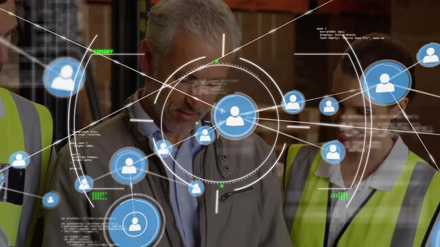Animation of connected icons, computer language over caucasian coworkers talking in warehouse