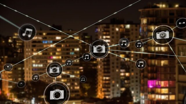 Animation of network of digital icons over aerial view of tall buildings against night sky