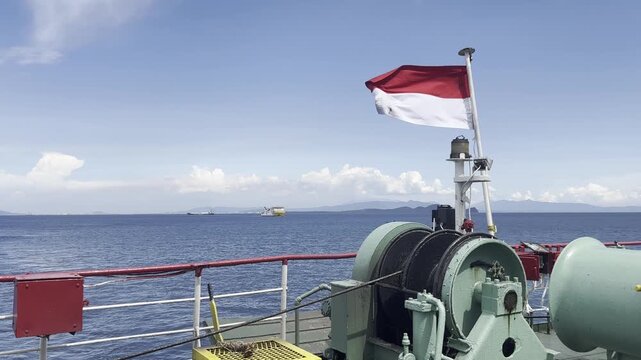 Indonesian Flag Flying on Ship Deck with Ocean Background Maritime Scene