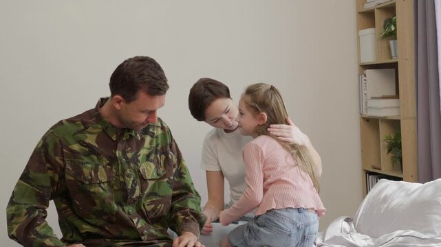 Cinematic video of a man coming back home from the army military service in the us. Family reunited at lunch time indoor in a beautiful american house.