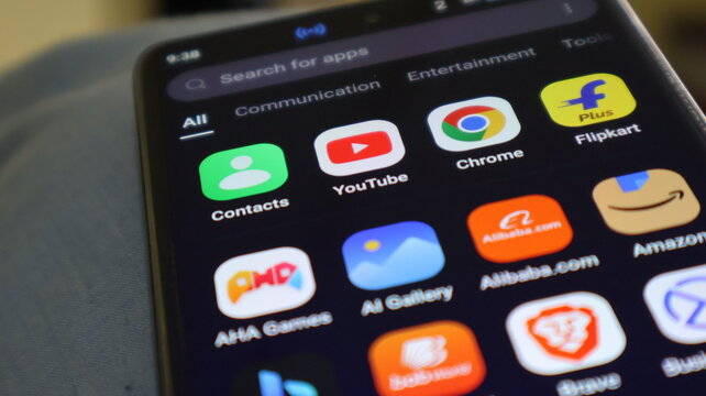 A smartphone screen displaying various apps and icons on a blurred background